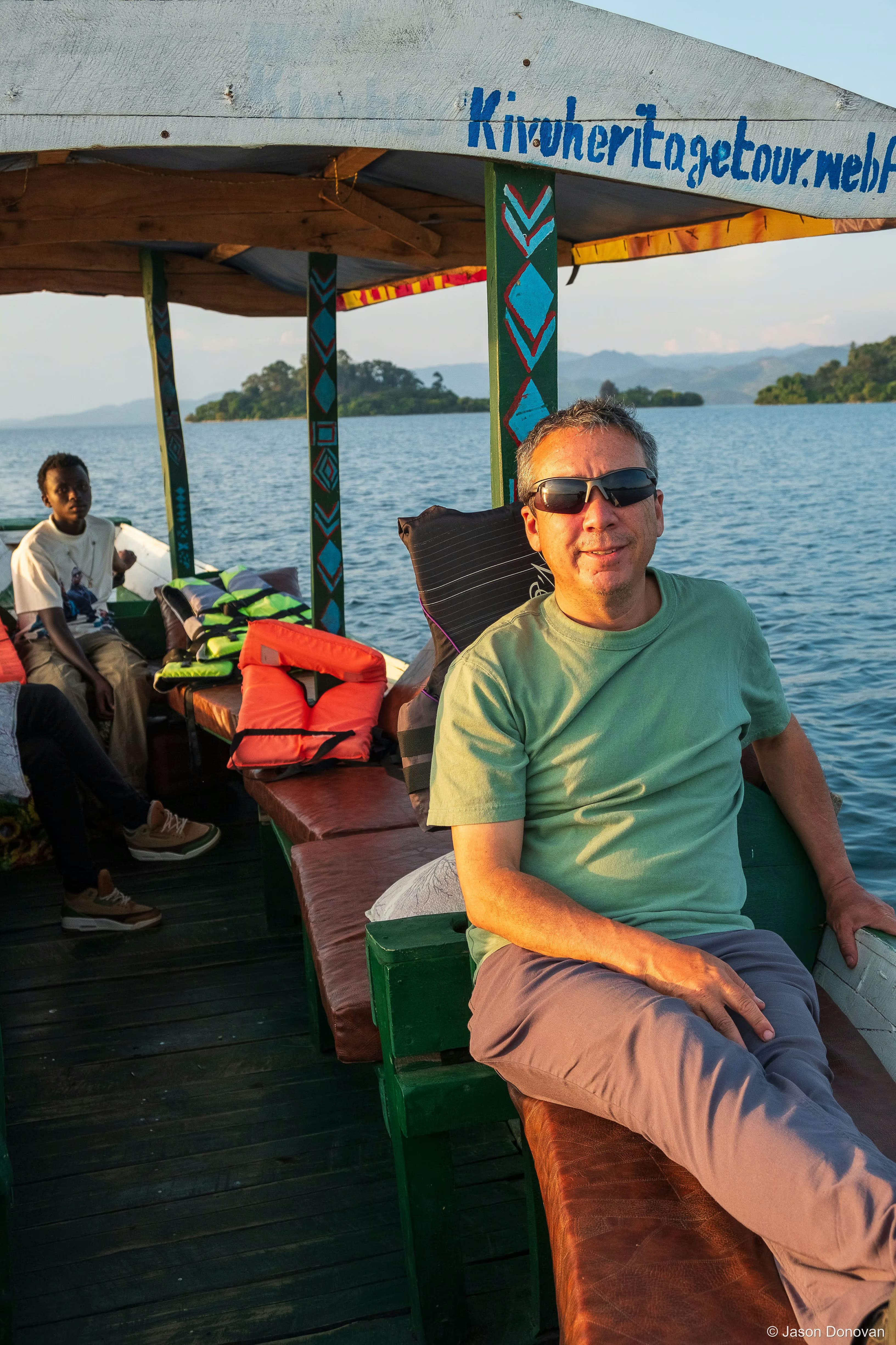 Tourist enjoying Boat Trip Rwanda photography by Jason Donovan